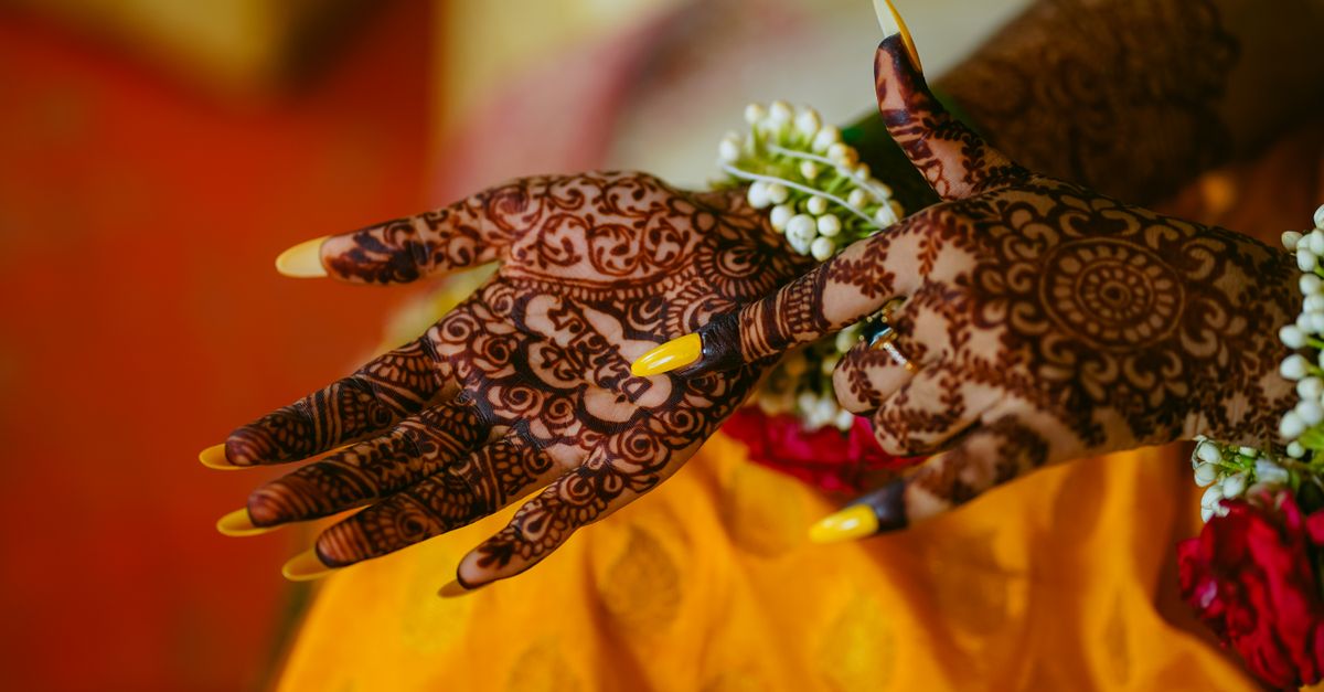 Detailed henna on a bride's hands at a mehndi night