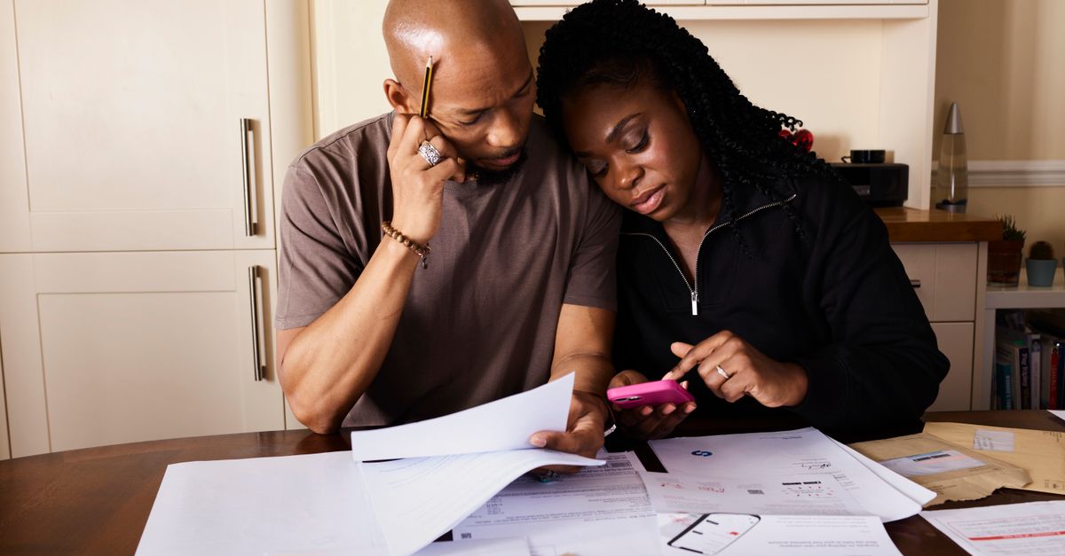 A couple reviewing a wedding budget spread across several events