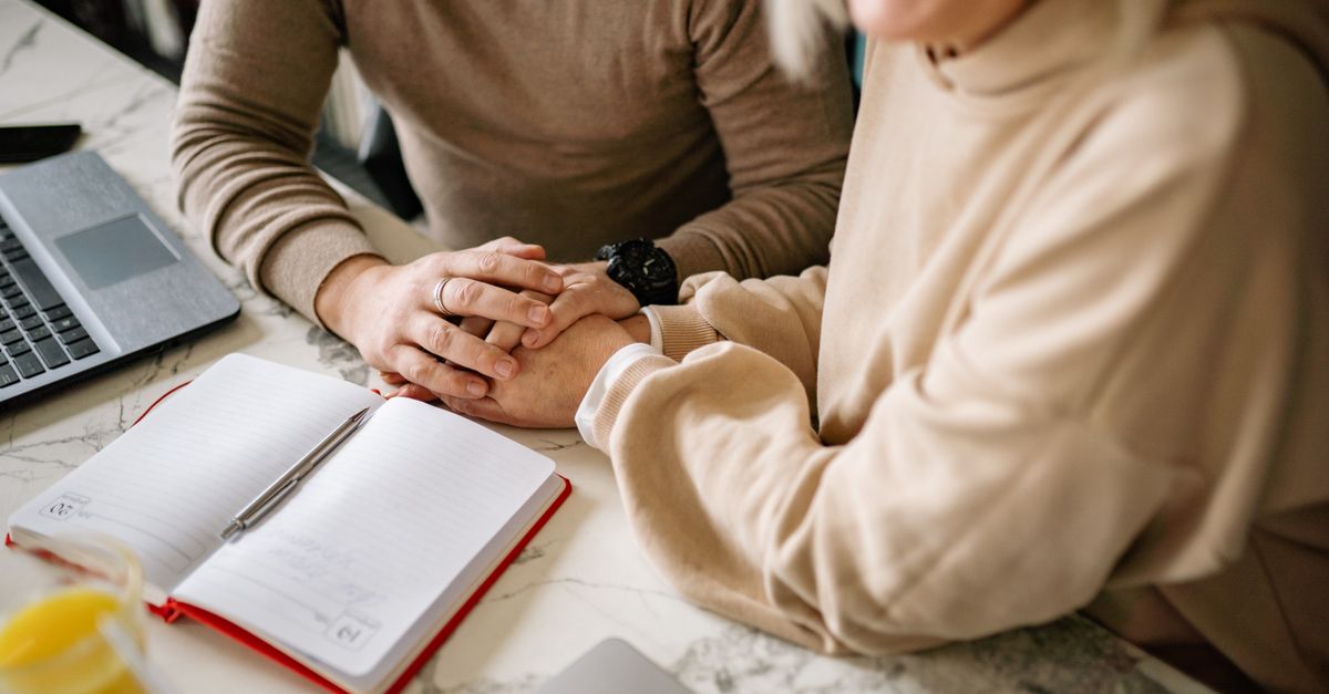 A couple working through a wedding planning checklist together